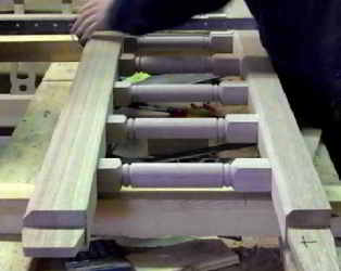 The turned spindles being glued into position within the Victorian gates