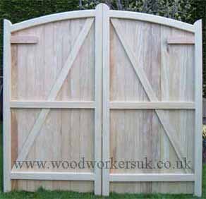 Rear view of Curved headed wooden driveway gates in Idigbo hardwood